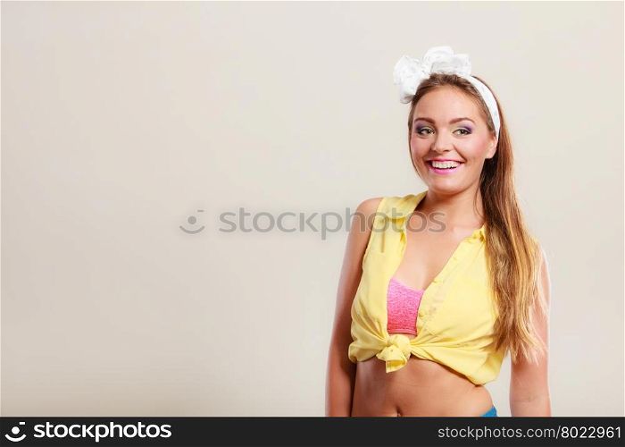 Alluring seductive pretty pin up girl with hairband bow. Attractive gorgeous young retro woman posing in studio.