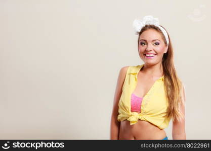 Alluring seductive pretty pin up girl with hairband bow. Attractive gorgeous young retro woman posing in studio.