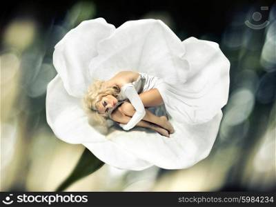 Alluring woman hiding herself into the flower