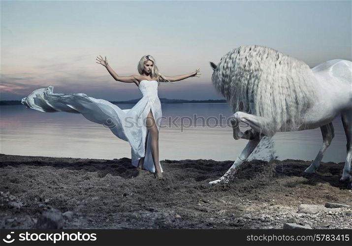 Alluring woman taming the white horse