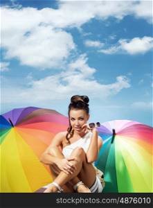 alluring woman with a bunch of colorful umbrellas