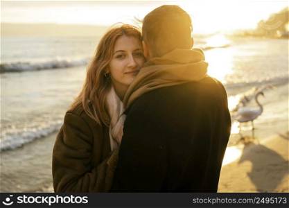 alluring woman with her boyfriend by beach winter