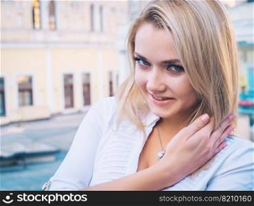 Alluring young blonde business woman on office buildings. Pretty lady in white sexy blouse looking at camera with smile. High quality photo. Alluring young blonde business woman on office buildings. Pretty lady in white sexy blouse looking at camera with smile.
