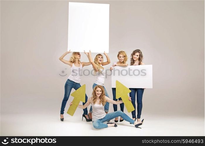 Alluring young women holding billboards