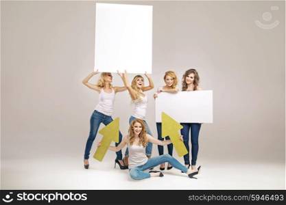 Alluring young women holding billboards