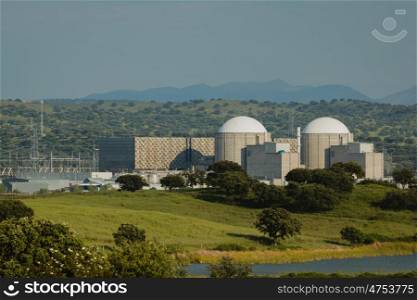 Almaraz nuclear power plant in the center of Spain, surrounded by a green field
