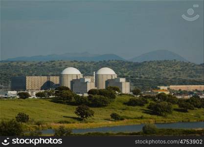 Almaraz nuclear power plant in the center of Spain, surrounded by a green field
