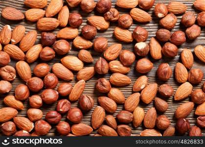 Almond and hazelnut on a wooden table. Background with nuts.