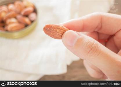 Almond grain roast salt on weathered wooden table, stock photo