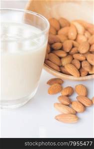Almond milk and grain on white kitchen table, stock photo