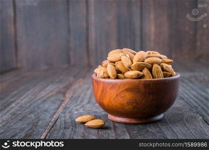 Almond on wooden background - vintage old effect stlye pictures