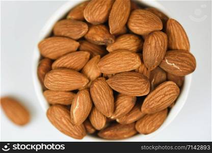 Almonds bowl isolated on gray background / Close up almond nuts natural protein food and for snack , selective focus