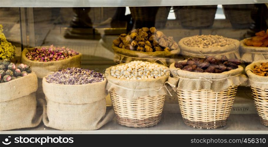 Almonds, figs, apricots, pistachios and herbal teas in straw baskets