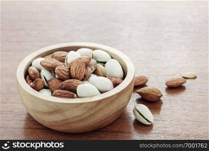 Almonds in bowl on wood floors.