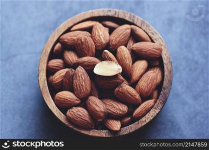 Almonds nuts on wooden bowl, Close up roasted almond nuts natural protein food and for snack