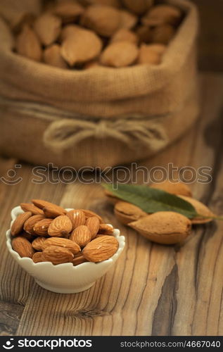 Almonds on brown wooden background. Beneficials for the brain