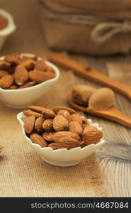 Almonds on brown wooden background. Beneficials for the brain