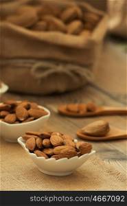 Almonds on brown wooden background. Beneficials for the brain