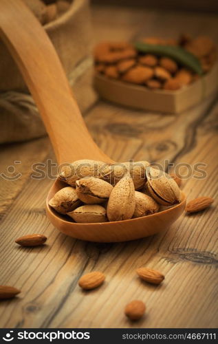 Almonds on brown wooden background. Beneficials for the brain