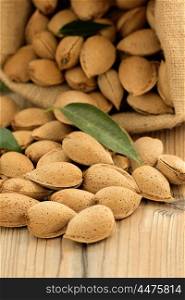 Almonds on brown wooden background with the focus in the foreground