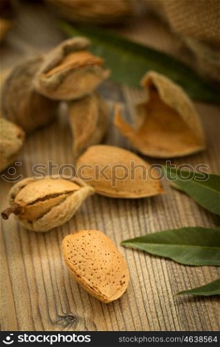 Almonds on brown wooden background with the focus in the foreground