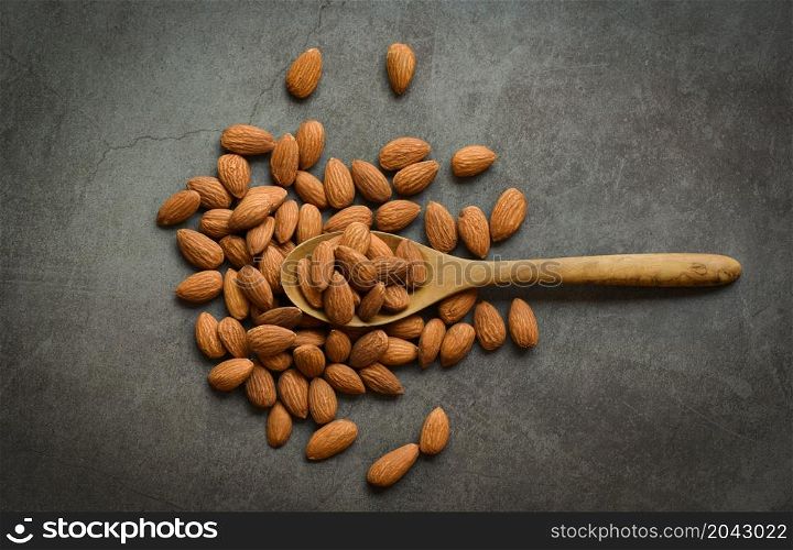 Almonds on dark background top view on the table, Close up roasted almond nuts natural protein food and for snack