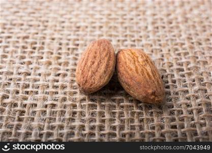 Almonds placed on a linen canvas background