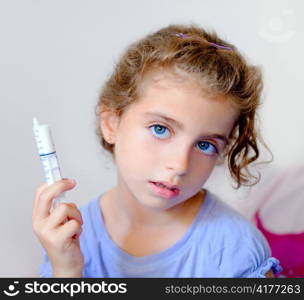 almost happy children kid girl with syringe of antibiotic medicine