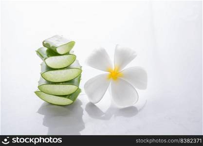 Aloe vera and plumeria decorated for a spa or skin cream is placed on  white background,aloe vera is tropical green plants.Sliced Aloe Vera natural organic renewal cosmetics,Organic Skin care concept.