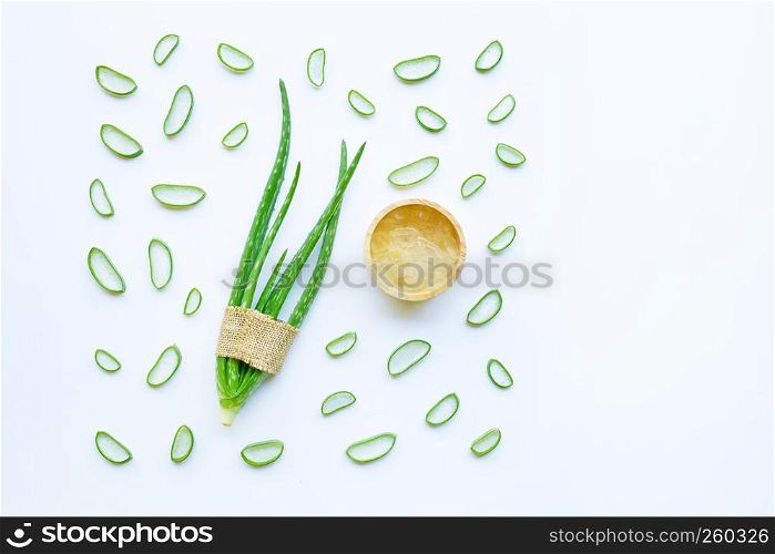 Aloe vera and slices with aloe vera gel in wooden bowl isolated on white background.