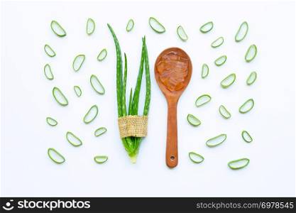 Aloe vera and slices with aloe vera gel on wooden spoon isolated on white background.