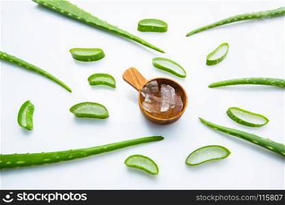 Aloe vera fresh leaves with aloe vera gel on wooden measuring spoon. isolated over white