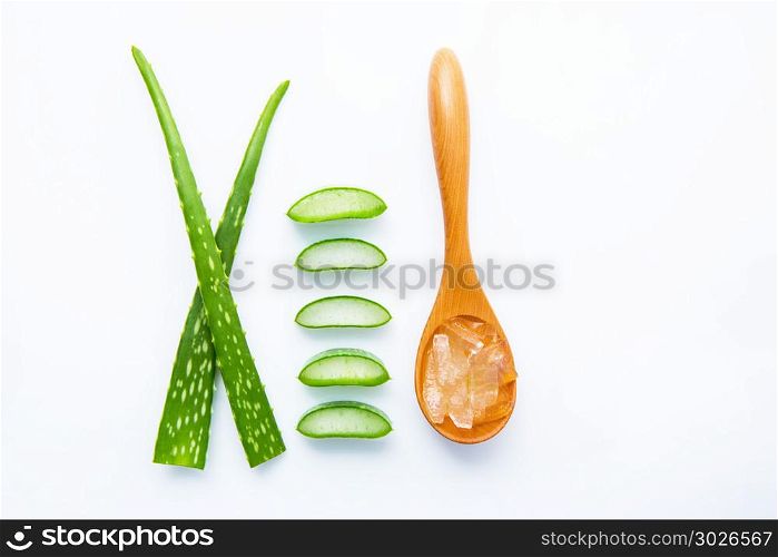 Aloe vera fresh leaves with aloe vera gel on wooden spoon. isolate