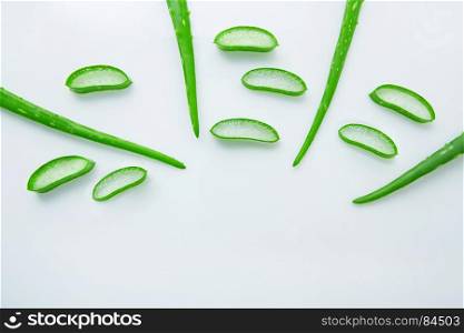 Aloe vera fresh leaves with slices aloe vera gel on wooden spoon. isolated over white