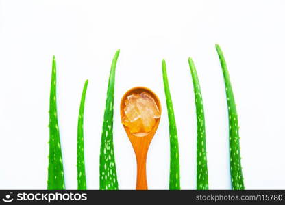 Aloe vera fresh leaves with slices and aloe vera gel on wooden spoon. isolated over white