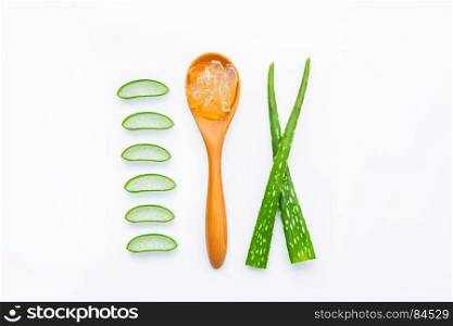 Aloe vera fresh leaves with slices and aloe vera gel on wooden spoon. isolated over white