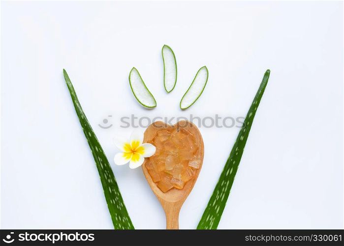 Aloe vera fresh leaves with slices and gel on wooden spoon. isolated over white. Aloe vera is a popular medicinal plant that is used for health and beauty.