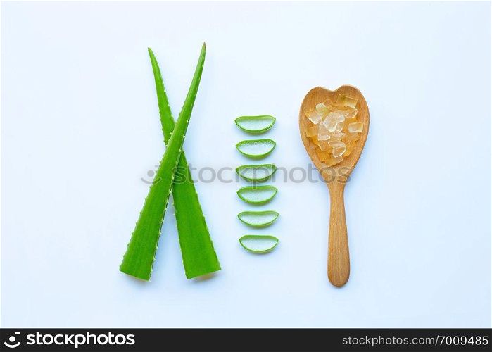Aloe vera fresh leaves with slices and gel on wooden spoon. isolated over white. Aloe vera is a popular medicinal plant that is used for health and beauty. 