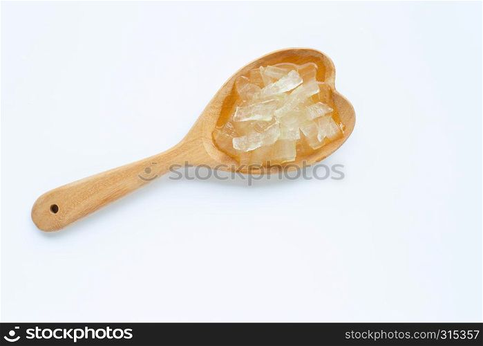 Aloe vera gel on wooden spoon on white background. Aloe vera is a popular medicinal plant for health and beauty,