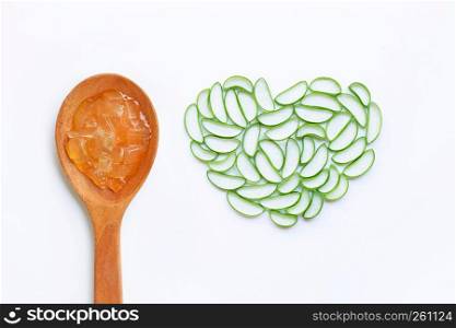 Aloe vera gel on wooden spoon with aloe vera slices on white background, heart shaped