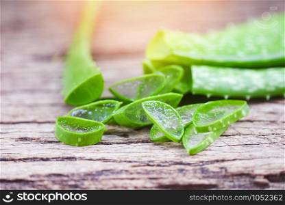 aloe vera plant slice on rustic wood background / close up of fresh aloe vera leaf with gel natural herbs and herbal medicines