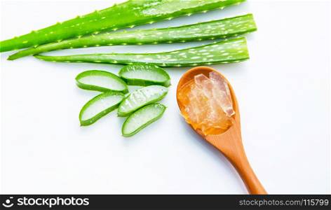 Aloe vera sliced isolated on brown wooden spoon on white background.