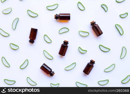 Aloe vera slices with bottle of essential oils on white