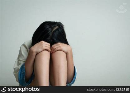 Alone and scared, sad depressed children crying in the dark room after being bullied