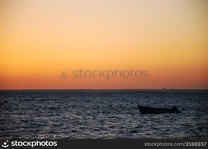 Alone boat in sunset.