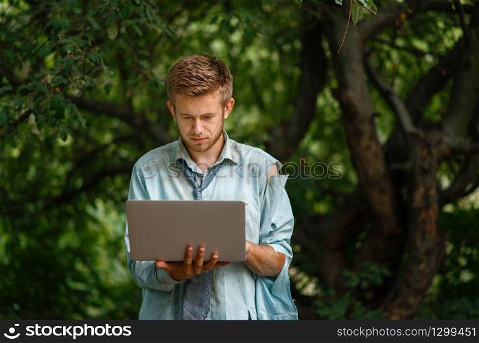 Alone businessman with laptop on desert island. Business risk, collapse or bankruptcy concept. Alone businessman with laptop on desert island