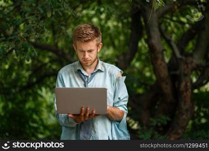 Alone businessman with laptop on desert island. Business risk, collapse or bankruptcy concept. Alone businessman with laptop on desert island