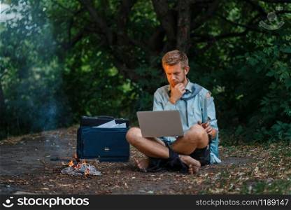 Alone office worker with laptop on desert island. Business risk, collapse or bankruptcy concept. Alone office worker with laptop on desert island