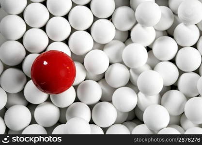 Alone one billiard red ball between little white table football balls