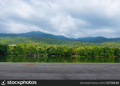 Along road landscape view in Ang Kaew Chiang Mai University Forested Mountain blue sky background with white clouds, Nature Road in mountain forest.